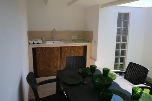 a dining room with a table with chairs and a sink at Bienestar House in Blanes