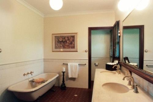 a bathroom with a sink, toilet and bathtub at Pinctada McAlpine House in Broome