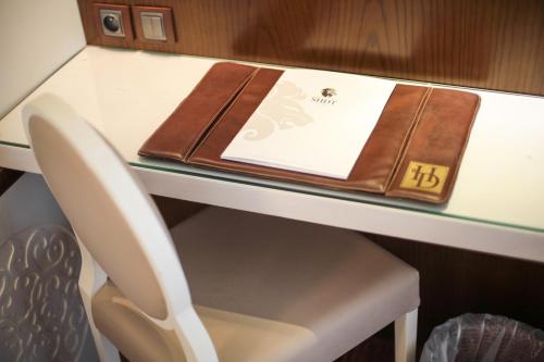 a table with a book and a notebook on it at Sousse Palace Hotel & Spa in Sousse