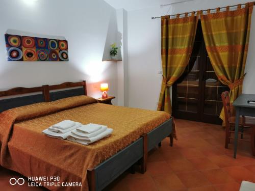 a bedroom with a bed with towels on it at Sole e Luna Capo Vaticano in Ricadi