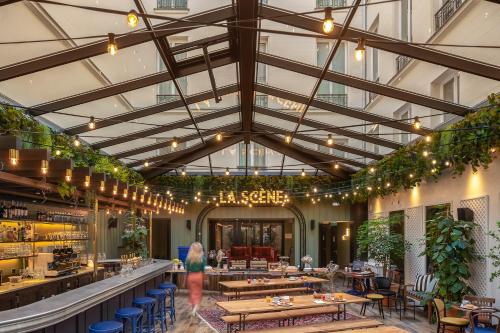 a rendering of a restaurant with a large ceiling at Chouchou Hotel in Paris