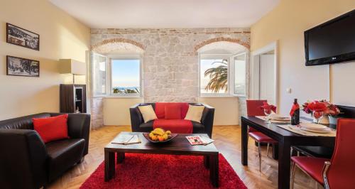 a living room with a couch and a table at Luxury Apartment Riva with a magnificient view in Split