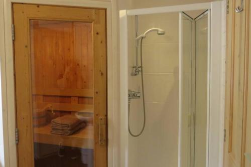 a bathroom with a shower with a glass door at Cul Darach Lodge, Glen Roy Nature Reserve in Roybridge