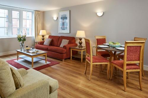 a living room with a couch and a table at Marlin Apartments London City - Queen Street in London