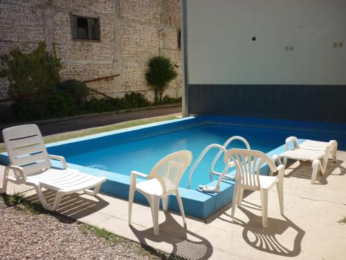 a group of chairs sitting next to a swimming pool at Bonito Hotel in San Rafael