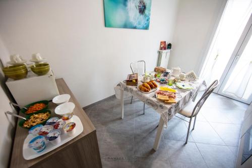 a table with many plates of food on it at ART & BOOKS bed and breakfast in Mantova