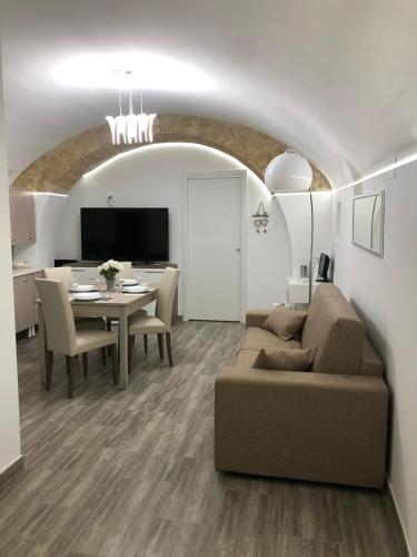 a living room with a couch and a table at Dimora Vittoria in Bari