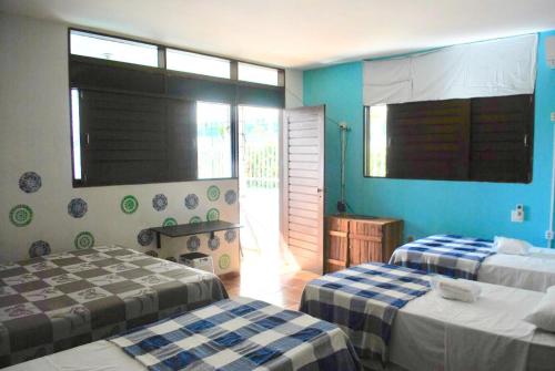 A bed or beds in a room at Regiane Beach Pousada Hostel