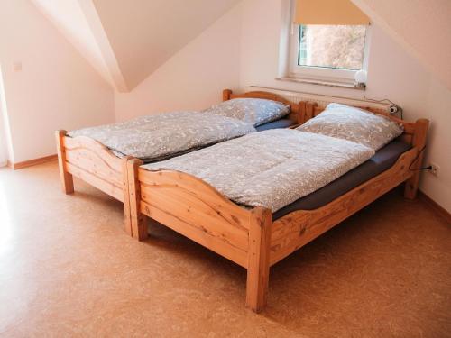 two wooden beds in a room with a window at Ferienhaus Paula in Olsberg