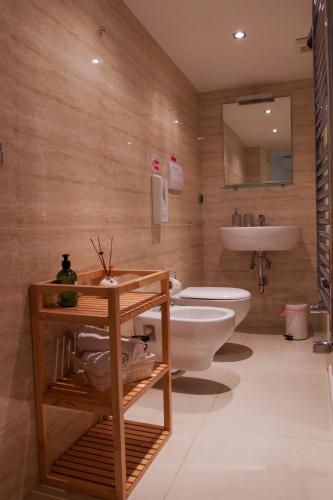 a bathroom with a white toilet and a sink at La Cattedrale in Ruvo di Puglia