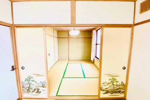 an inside view of a room with glass doors at Manyi's Onsen House 天然温泉マンイの湯 in Shiraoi