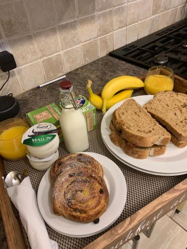 two plates of bread and milk on a kitchen counter at Kenilworth Guest House in Windermere