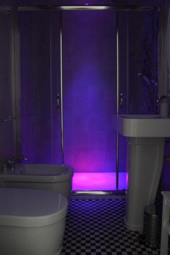 a purple bathroom with a tub and a toilet at B&B Dei Cardinale in Bari