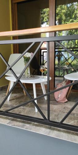 a table and a chair on a balcony at Tošić apartman in Sombor