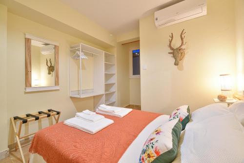 a bedroom with a bed with two towels on it at Elevator's Beach House by Atlantic Places in Albufeira