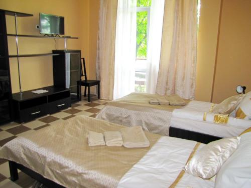 een hotelkamer met 2 bedden en een raam bij Перлина in Morshin
