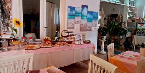 a table with food on a pink table cloth at Hotel Ristorante La Terrazza in Lido di Camaiore