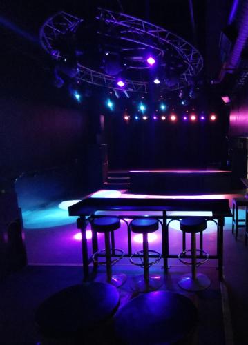 a ping pong table in a dark room with lights at Hotelli Iisoppi in Nokia
