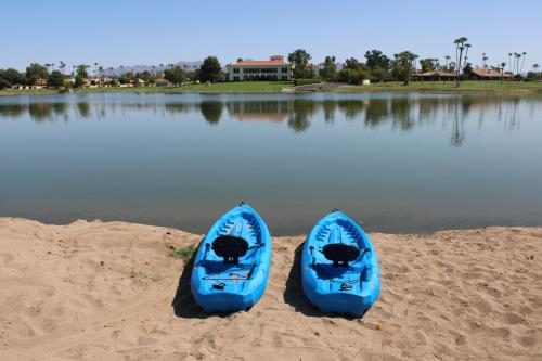 two blue kayaks sitting on the sand near the water at The McCormick Scottsdale in Scottsdale