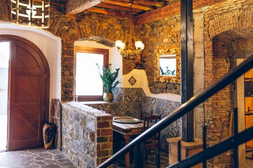 a staircase in a room with a stone wall at AQUILA D'ORO TRIESTE in Trieste