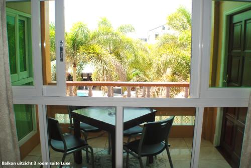a view of a balcony with a table and chairs at Joah Inn Appartementen in Paramaribo