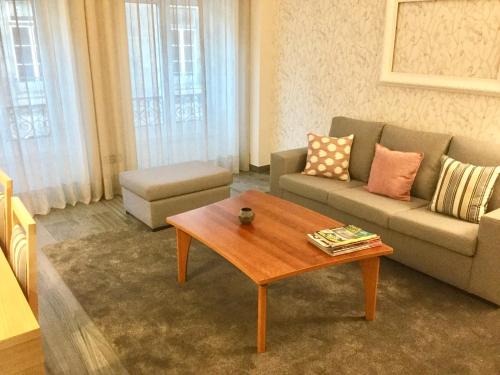 a living room with a couch and a coffee table at Central & Charming Clérigos Appartments in Porto