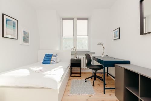 biała sypialnia z łóżkiem i biurkiem w obiekcie ShortStayPoland Jana Pawła (B11) w Warszawie