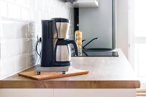 a black coffee maker on a counter in a kitchen at Dziesiąte Piętro in Poznań