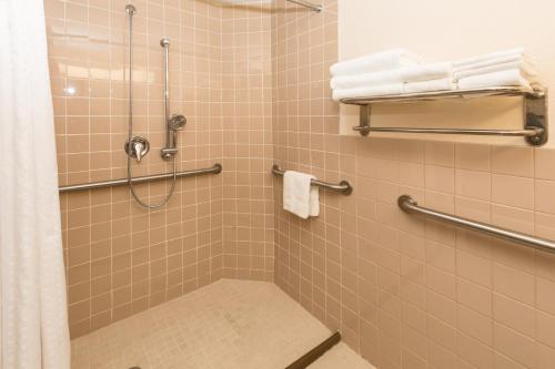 a bathroom with a shower with white towels at Holiday Inn Miami Beach-Oceanfront by IHG in Miami Beach
