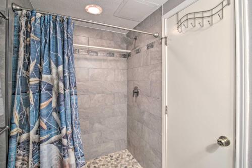 Una ducha con una cortina de ducha azul en un baño. en Sunny Oceanfront Condo on South Padre Island Beach, en South Padre Island