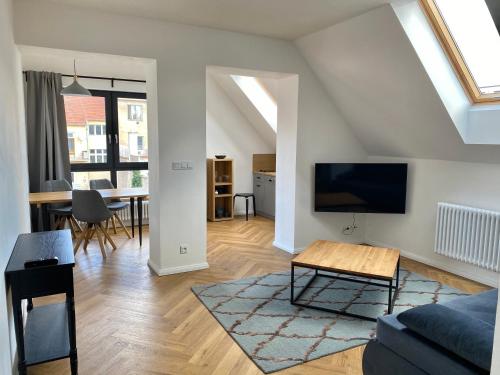 a living room with a couch and a tv at Design Pension Twenty 20 in Poděbrady