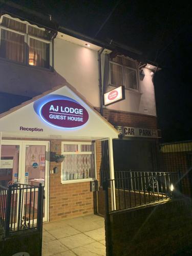 a quest house sign on the front of a building at AJ Lodge in Slough
