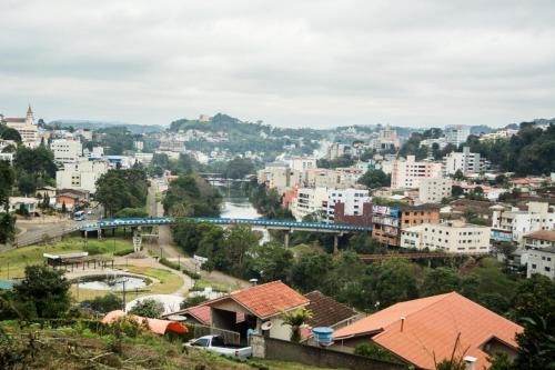 a view of a city with a train in the distance at Verde Vale Hotel in Videira
