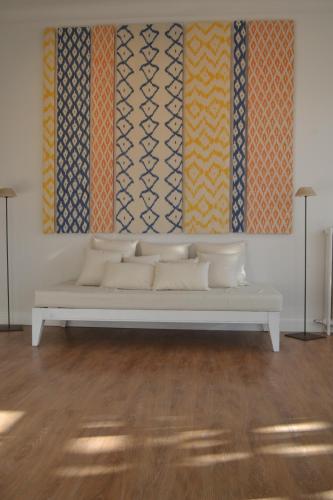 a white couch in a room with a painting at Hotel Miramar in Port de Soller
