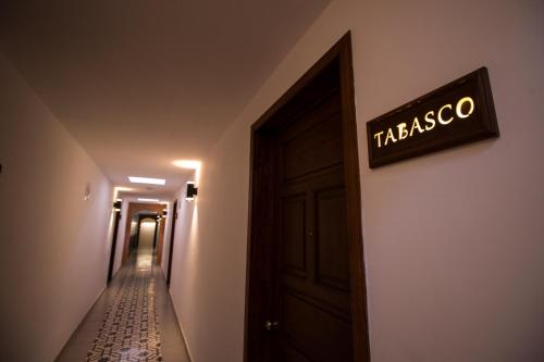 a sign that reads tracoco on a wall next to a door at Hotel Santa Rosa in Cholula