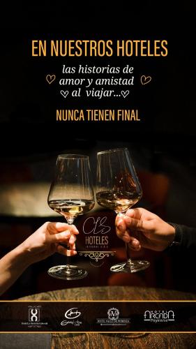 two people holding glasses of wine on a table at Hotel La Herreria Colonial in Popayan