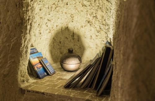 a vase sitting on a shelf in a stone wall at Atilla's Cave Hotel in Nevsehir