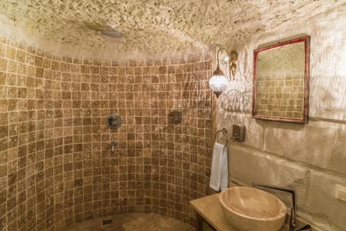 a bathroom with a sink and a mirror at Atilla's Cave Hotel in Nevsehir