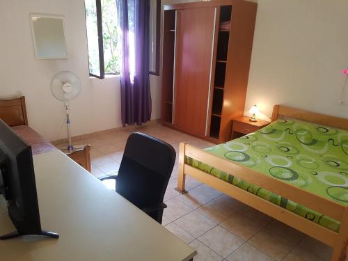 a bedroom with a bed and a desk with a computer at Extra Spacious Seaview Apartments close to the beach, with large terraces and FREE WI-FI & AC & BBQ & parking space in Sali