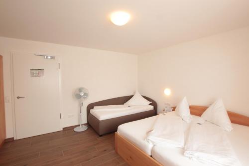 a bedroom with a bed and a sink in it at Hotel Sunnegässle in Rust
