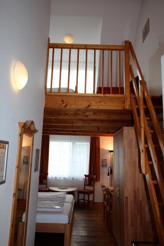 a room with a bunk bed and a staircase at Hotel Sunnegässle in Rust