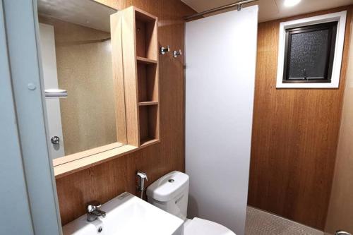 a bathroom with a toilet and a sink and a mirror at AniS Homestay Nilai USIM KLIA INTI Manipal Nilai 3 in Nilai
