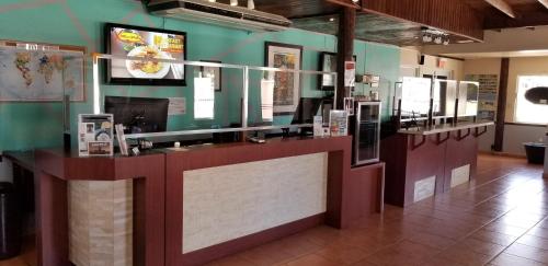 a restaurant with a counter with pictures on the wall at Combate Beach Resort in Cabo Rojo