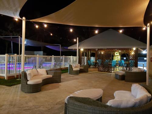 aented patio with chairs and a tent at night at Combate Beach Resort in Cabo Rojo
