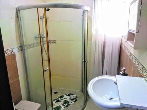 a bathroom with a shower and a sink at Herard share apartamento in Punta Cana