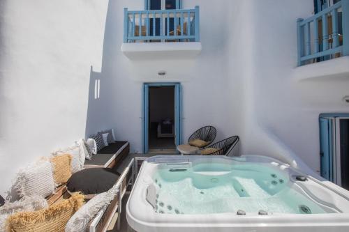 a bath tub in the middle of a room at Harmony Boutique Hotel in Mýkonos City