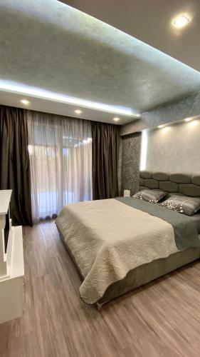 a bedroom with a large bed in a room at Paradise Swing Apartment Sofia in Sofia