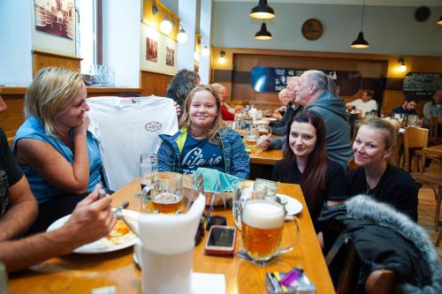 a group of people sitting at a table in a restaurant at Pension U Tří sedláků in České Budějovice