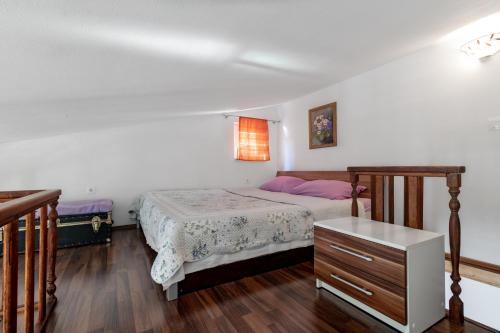 a bedroom with a bed and a dresser at Mirta in Stara Baška