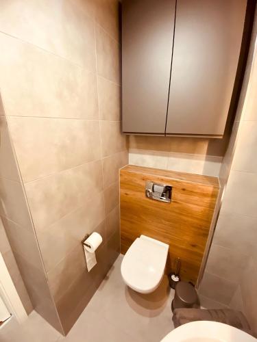 a small bathroom with a toilet and a cabinet at REWAL Komfortowy apartament przy plaży typu STUDIO in Rewal
